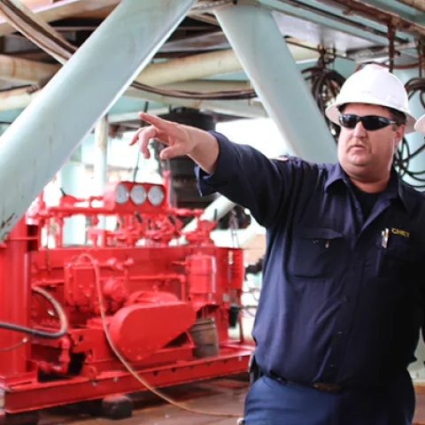 Offshore platform worker discussing equipment during inspection