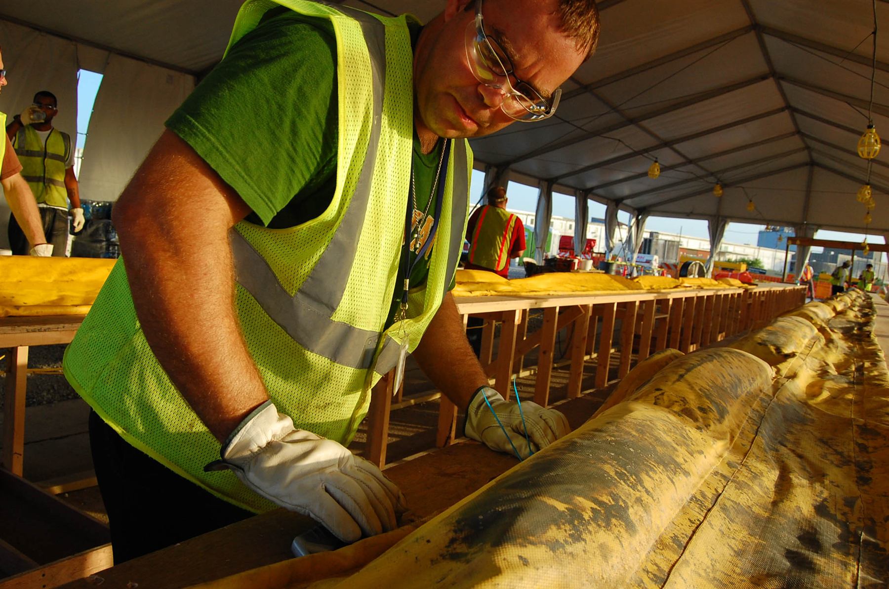 Worker handling oil response equipment during field safety operations